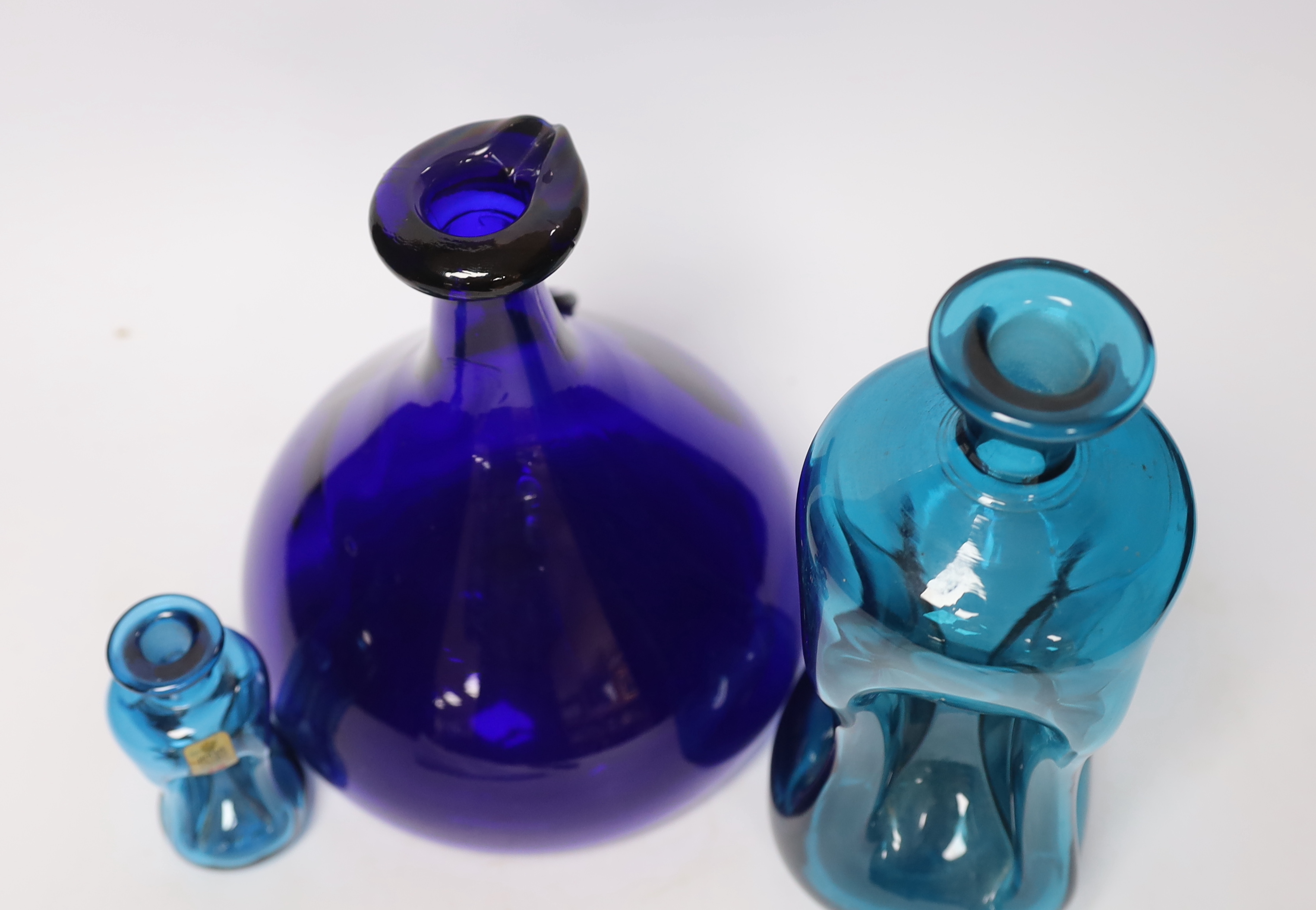 Three Holmegaard blue glass decanters, tallest 26cm high